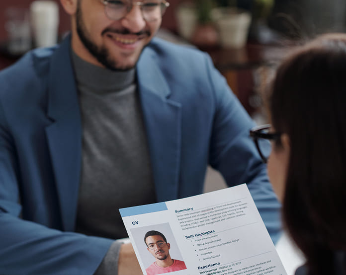 Interview setting with CV in foreground.
