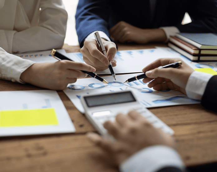 Business meeting discussing charts and data.