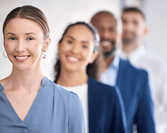 Diverse group of professionals smiling confidently.
