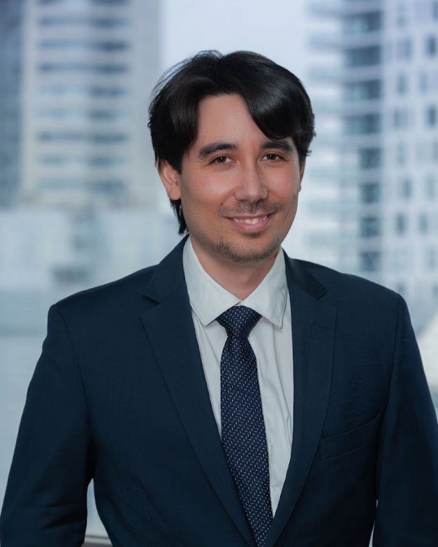 Professional man in navy suit smiling indoors